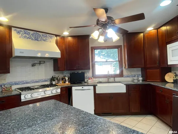 a kitchen view with stainless steel appliances a refrigerator and a counter top space