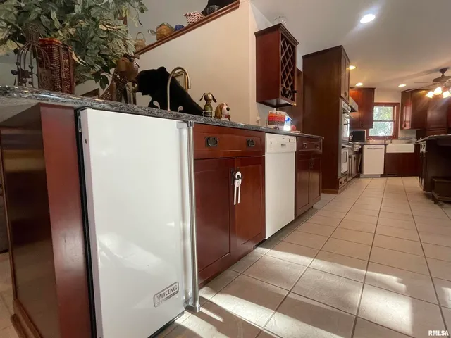 a living room with furniture a flat screen tv and kitchen view
