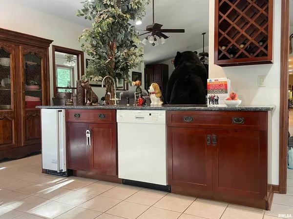 a kitchen with stainless steel appliances granite countertop a sink and a refrigerator