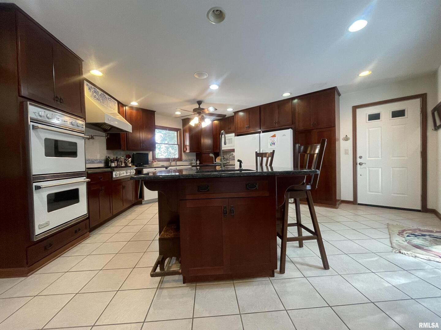 2479 New Era Road Murphysboro, IL 62966 - Photo 23 of 86 a kitchen with stainless steel appliances granite countertop a stove a sink a microwave and a refrigerator
