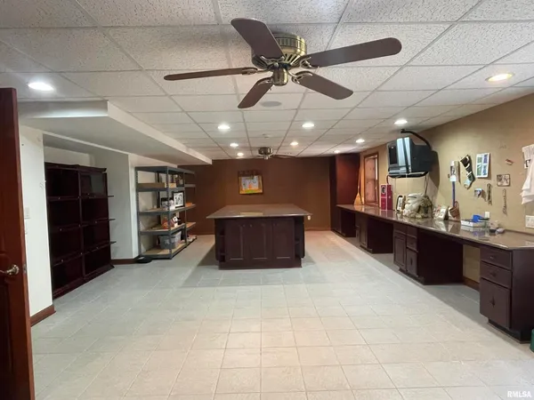 a view of a kitchen with kitchen island granite countertop a sink and a stove