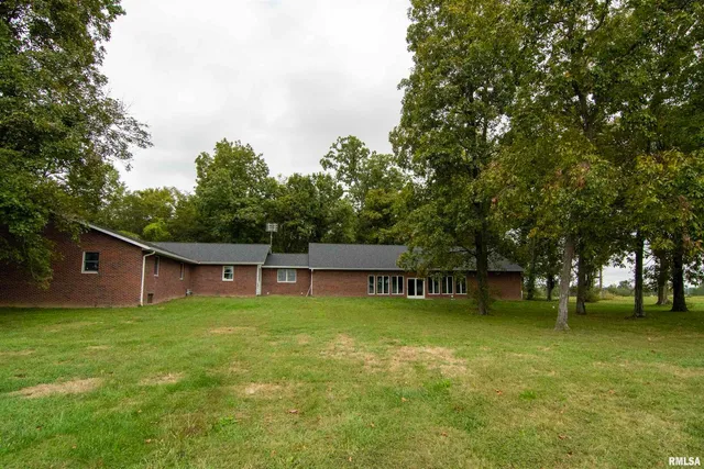 a view of a dining room with furniture a chandelier and window