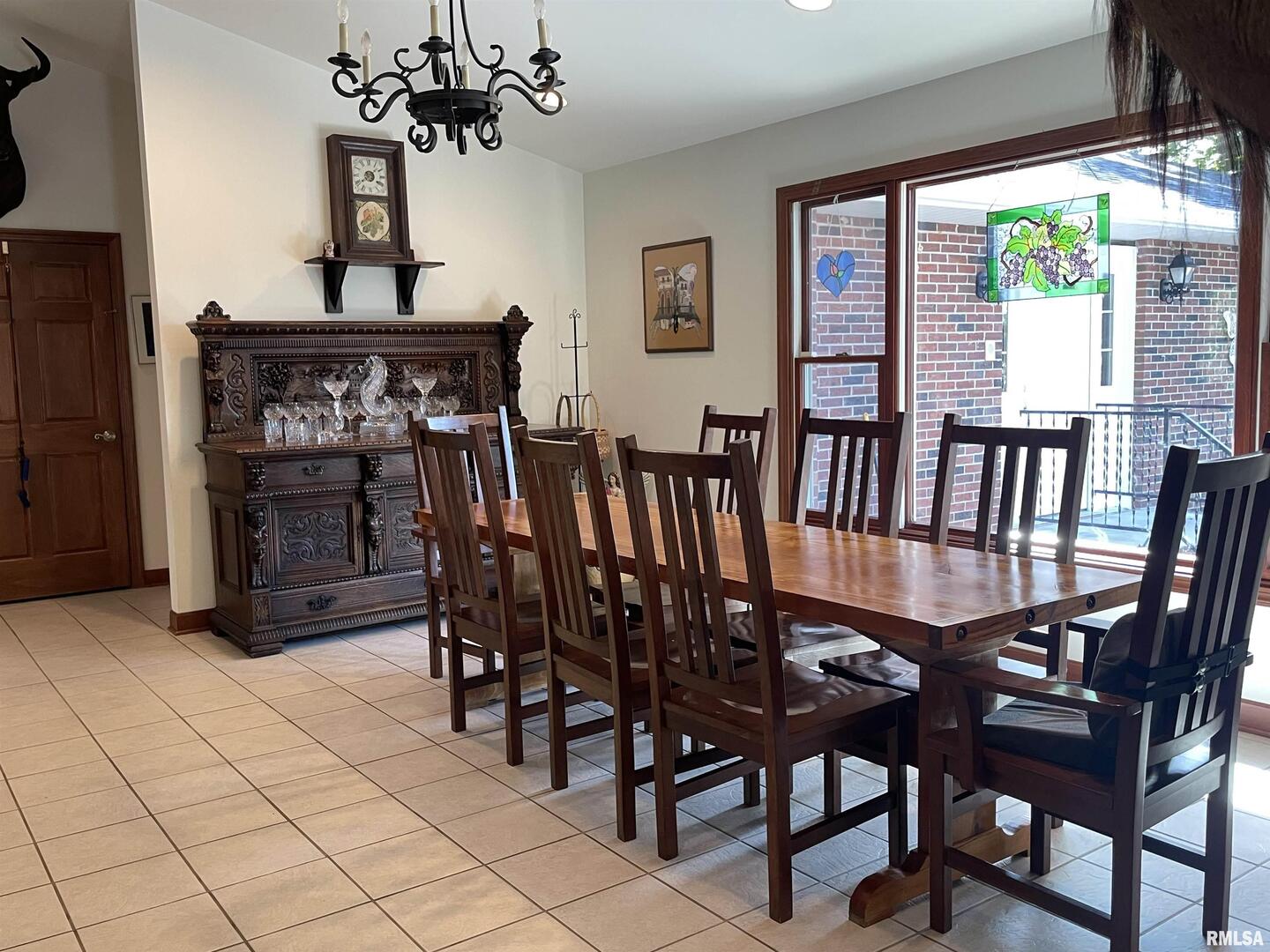 2479 New Era Road Murphysboro, IL 62966 - Photo 9 of 86 a view of a dining room with furniture a chandelier and window