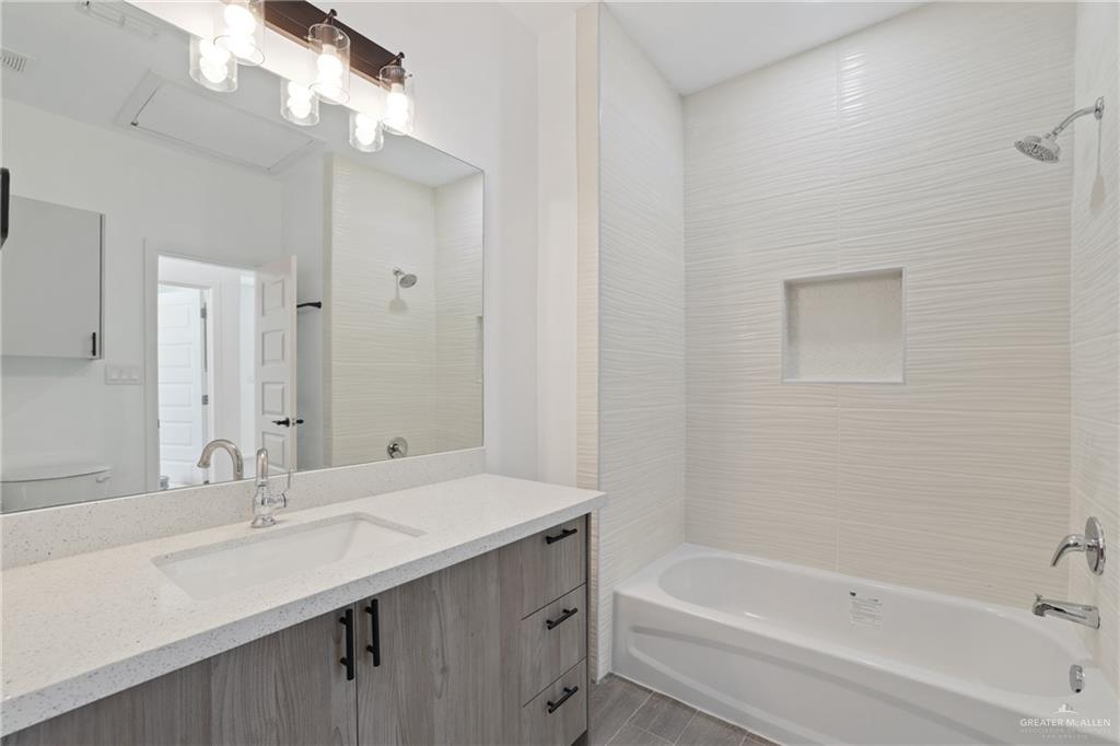 3208 Briggs Street, Unit 1 Weslaco, TX 78596 - Photo 11 of 12 Bathroom featuring visible vents, vanity, and shower / washtub combination