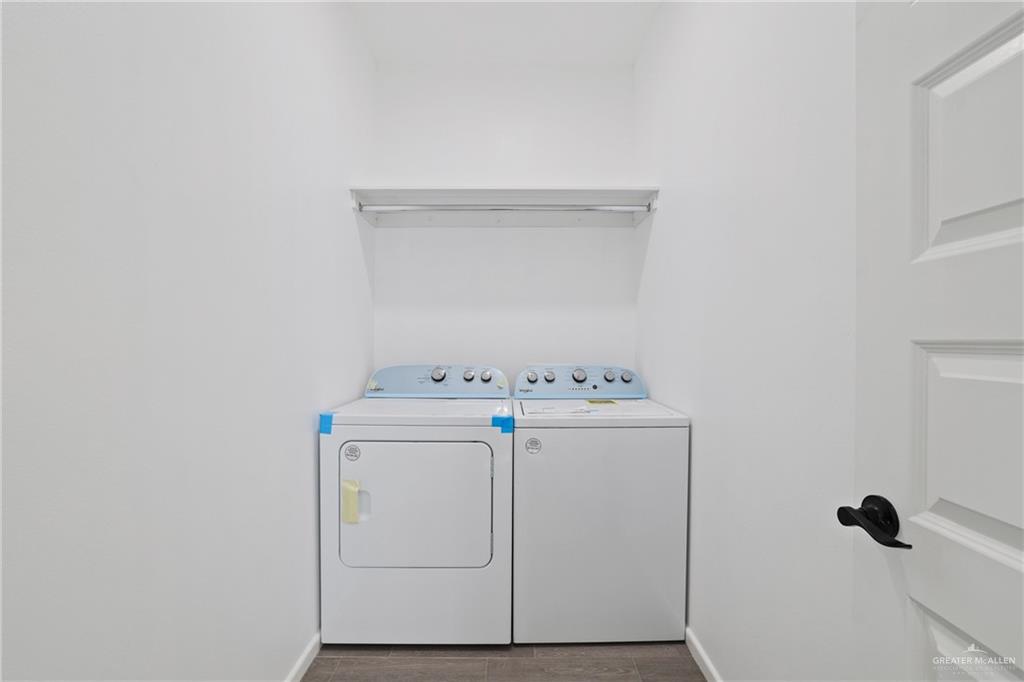 3208 Briggs Street, Unit 1 Weslaco, TX 78596 - Photo 12 of 12 Clothes washing area with washer and clothes dryer, laundry area, baseboards, and wood finish floors