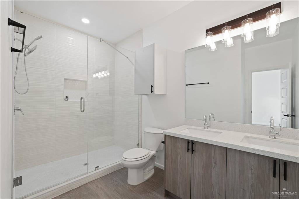 3208 Briggs Street, Unit 3 Weslaco, TX 78596 - Photo 4 of 10 Bathroom with a stall shower, a sink, and toilet