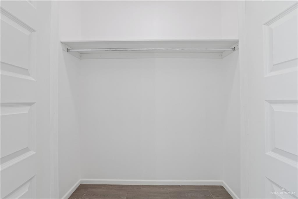 3208 Briggs Street, Unit 1 Weslaco, TX 78596 - Photo 9 of 12 Walk in closet with dark wood-type flooring