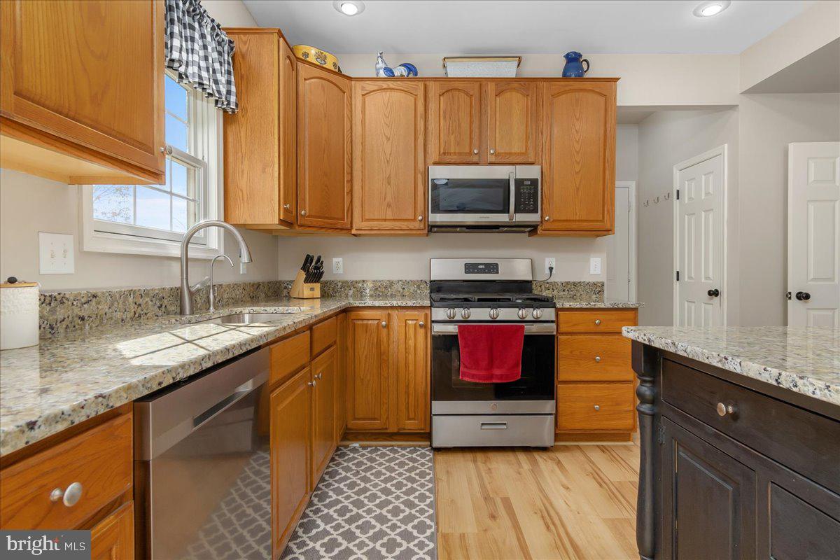 20376 Splendor View Terrace Hagerstown, MD 21740 - Photo 12 of 52 a kitchen with stainless steel appliances granite countertop a stove a sink and a microwave
