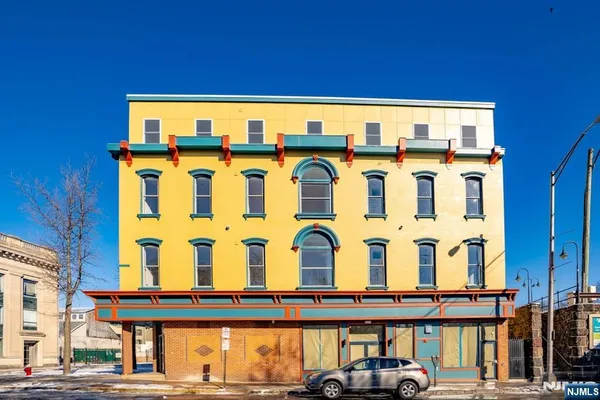 a front view of a building with parking area