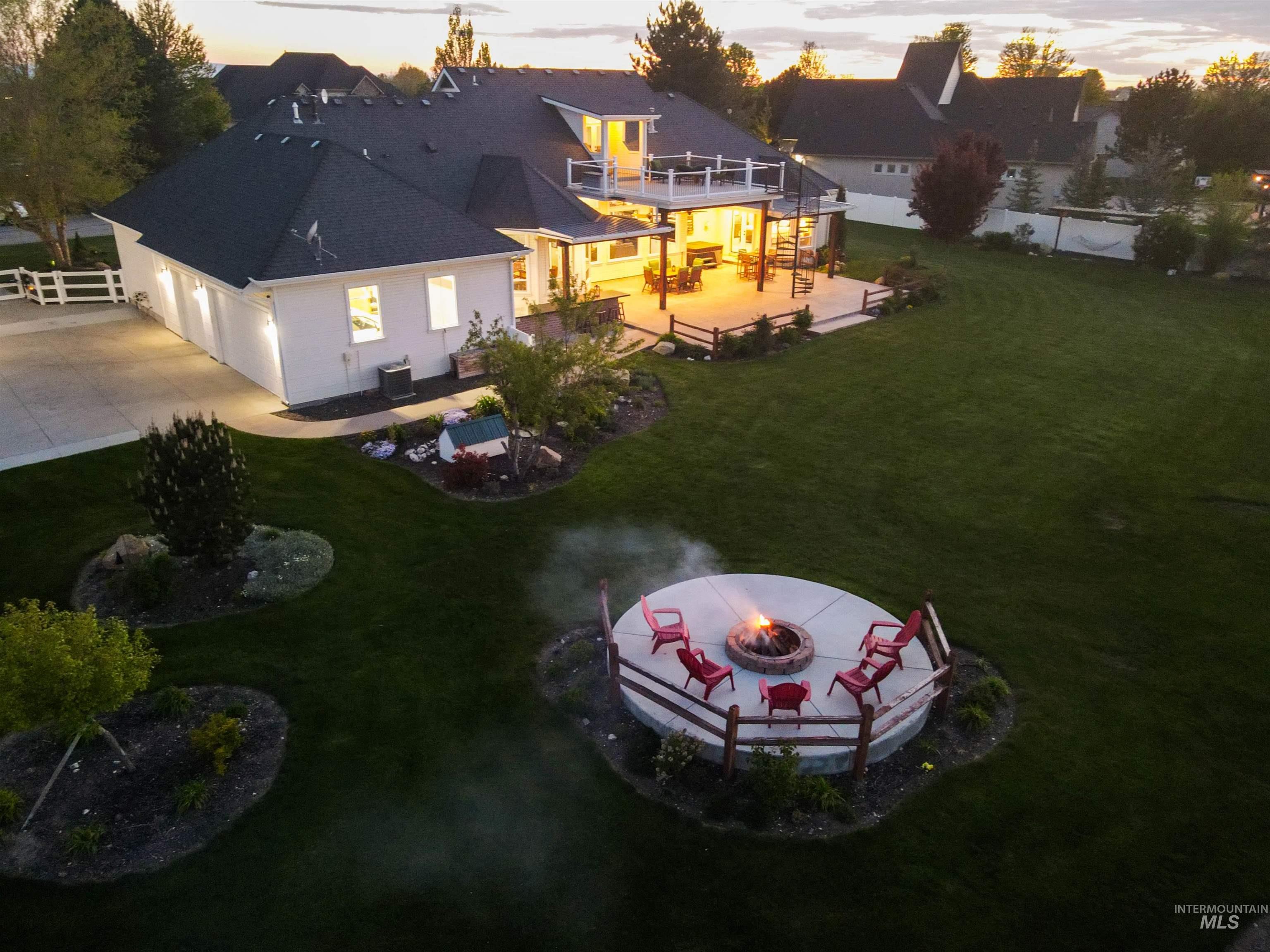 414 East Shafer View Drive Meridian, ID 83642 - Photo 2 of 50 On One Glorious Acre! AMAZING backyard featuring a circular fire pit with seating, a large upper deck with an outdoor living area, a lower covered patio, Private Fully fenced yard on Pressurized Irrigation.