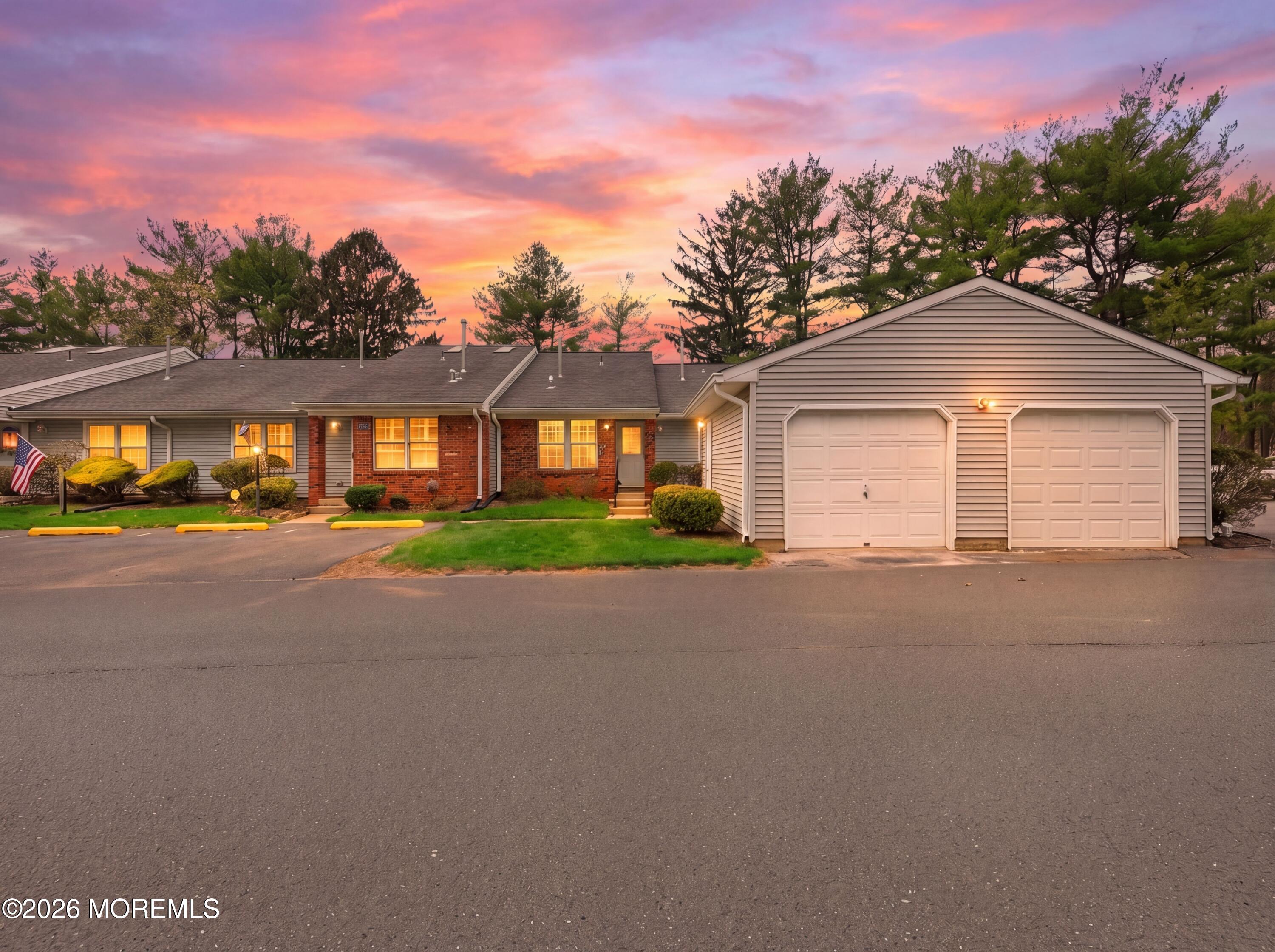 64 Boxwood Terrace Red Bank, NJ 07701 - Photo 1 of 32 a front view of a house with a yard and garage