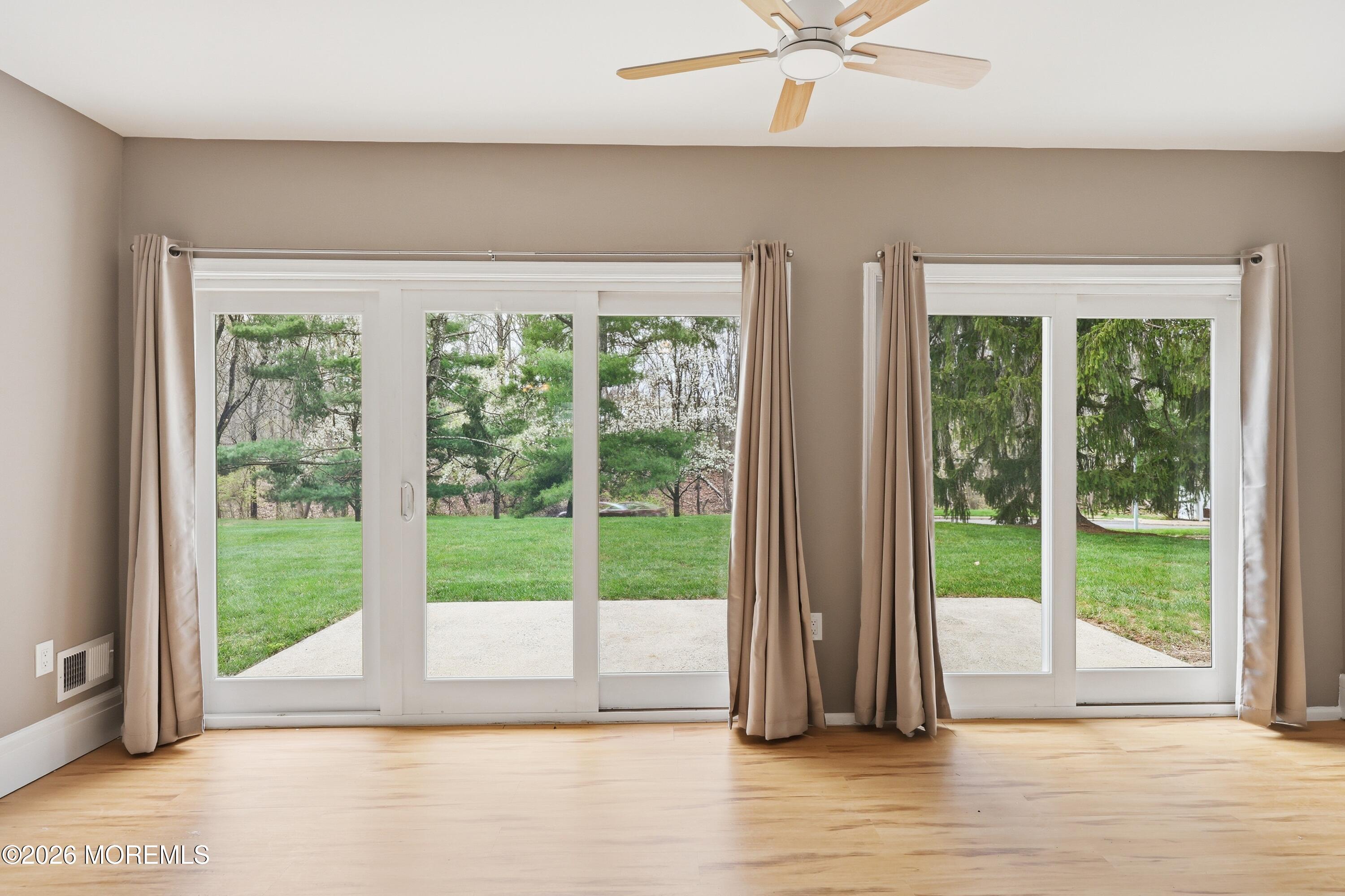 64 Boxwood Terrace Red Bank, NJ 07701 - Photo 11 of 32 a view of room with wooden floor and a floor to ceiling window