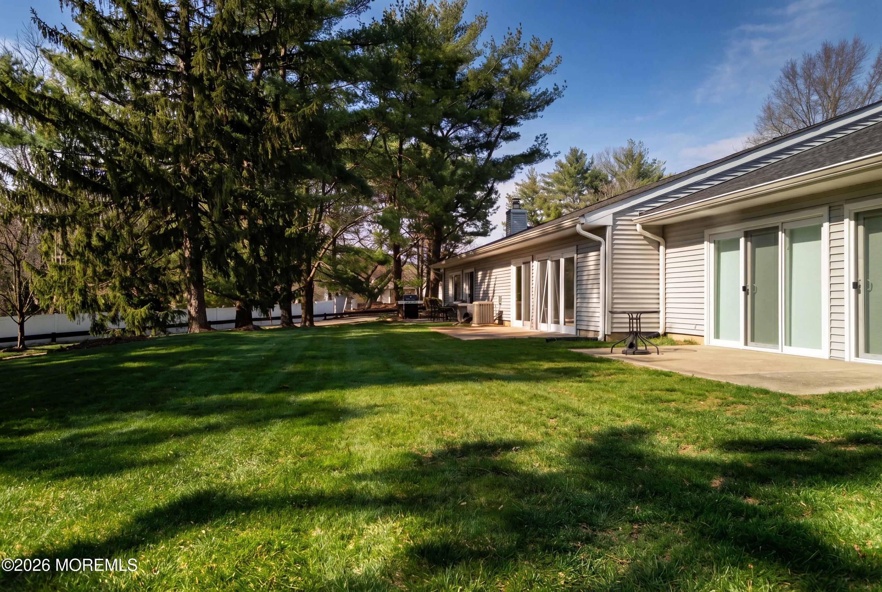 64 Boxwood Terrace Red Bank, NJ 07701 - Photo 26 of 32 a view of a house with a big yard plants and large trees