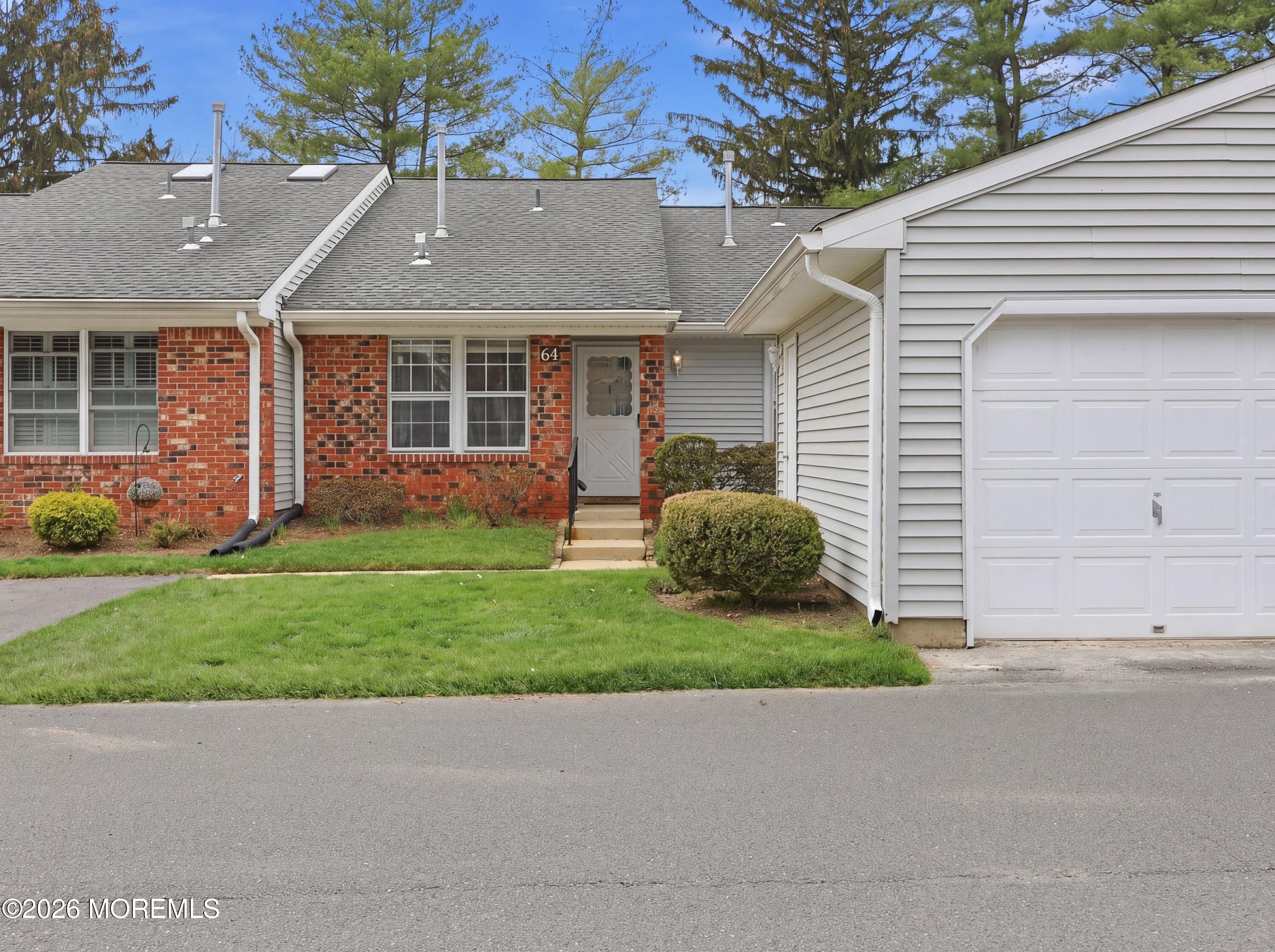 64 Boxwood Terrace Red Bank, NJ 07701 - Photo 3 of 32 a front view of a house with a yard and garage