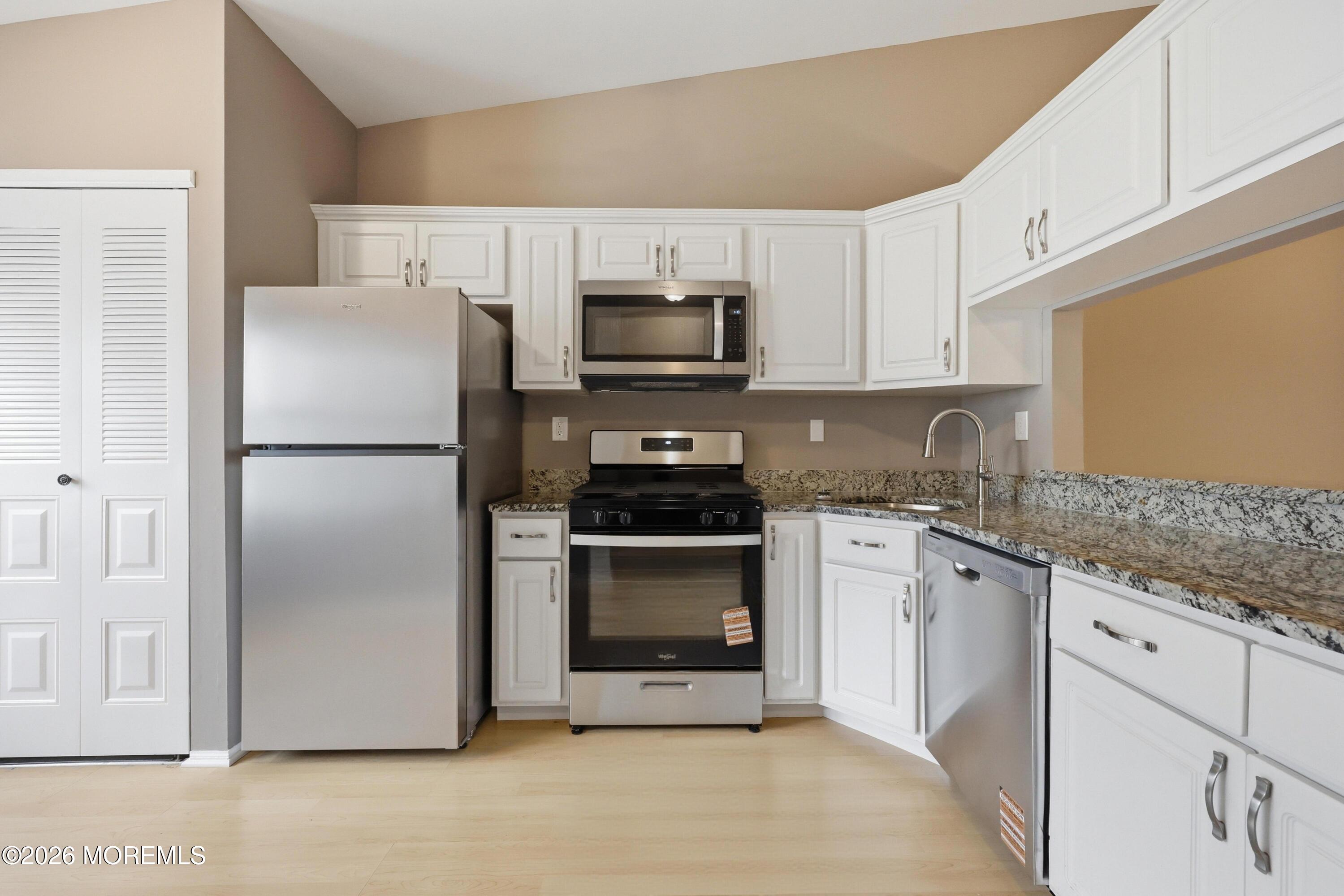 64 Boxwood Terrace Red Bank, NJ 07701 - Photo 4 of 32 a kitchen with a refrigerator stove and microwave