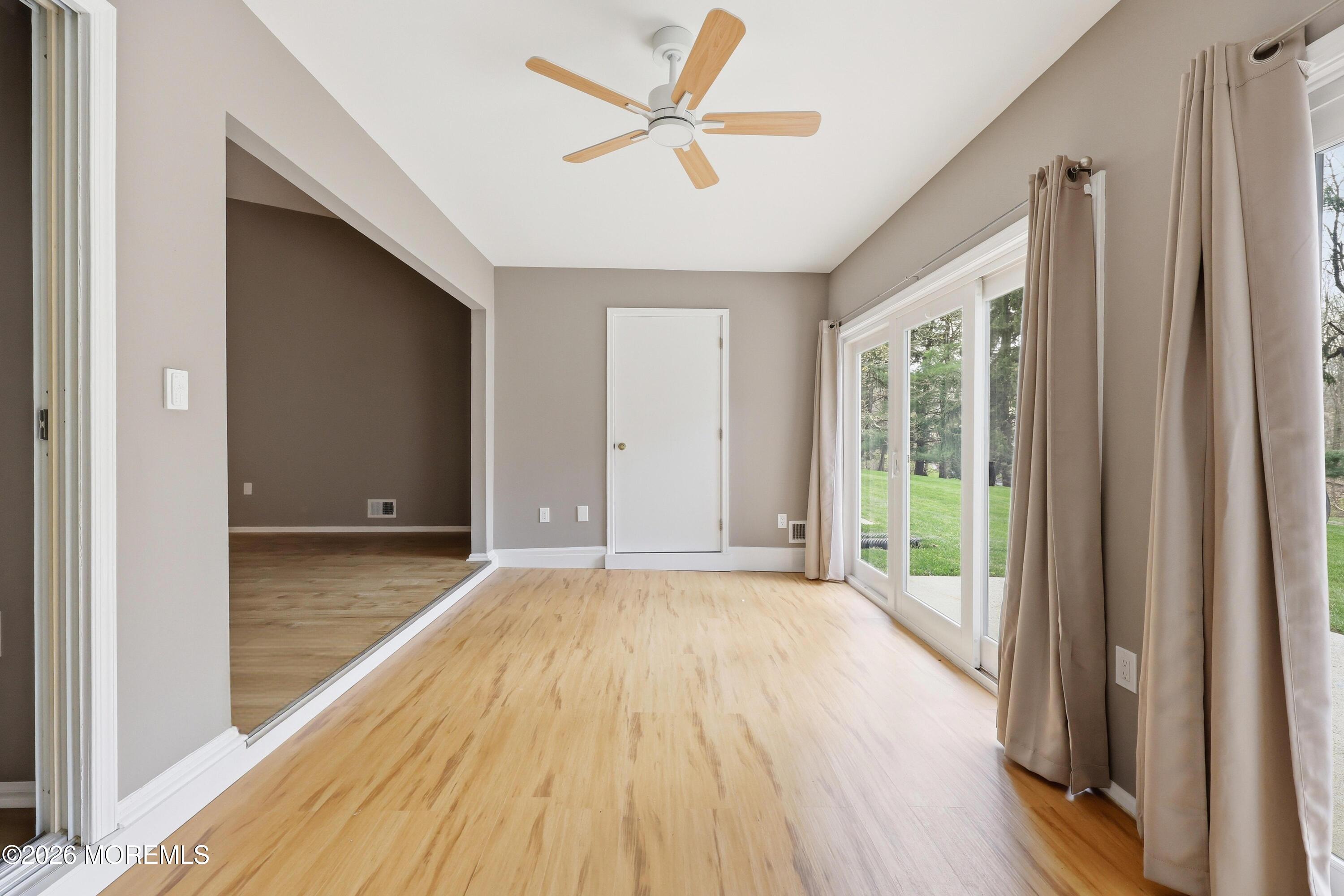 64 Boxwood Terrace Red Bank, NJ 07701 - Photo 9 of 32 a view of empty room with wooden floor and fan