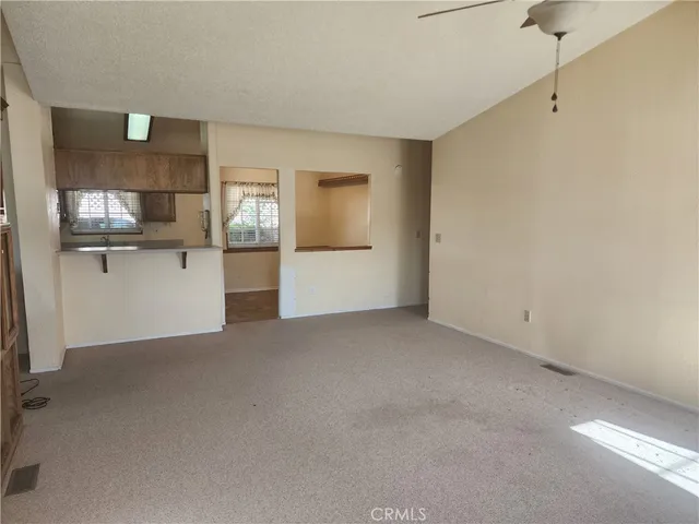 a view of a kitchen with a refrigerator and a sink