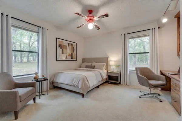 a bed room with a bed and a chair