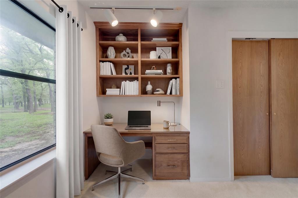 460 West J E Woody Road Springtown, TX 76082 - Photo 13 of 22 a view of a workspace with furniture and a window