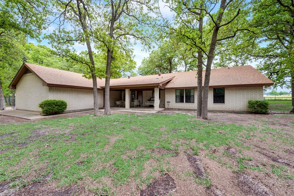 460 West J E Woody Road Springtown, TX 76082 - Photo 15 of 22 a view of a house with backyard and garden
