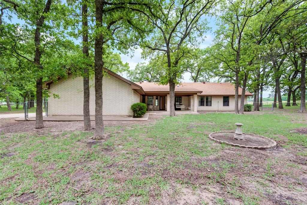 460 West J E Woody Road Springtown, TX 76082 - Photo 17 of 22 a front view of house with yard and green space