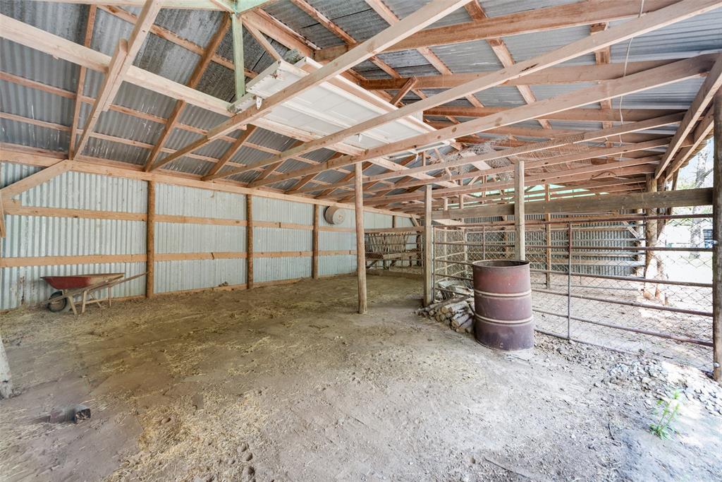 460 West J E Woody Road Springtown, TX 76082 - Photo 20 of 22 a view of a room with wooden racks