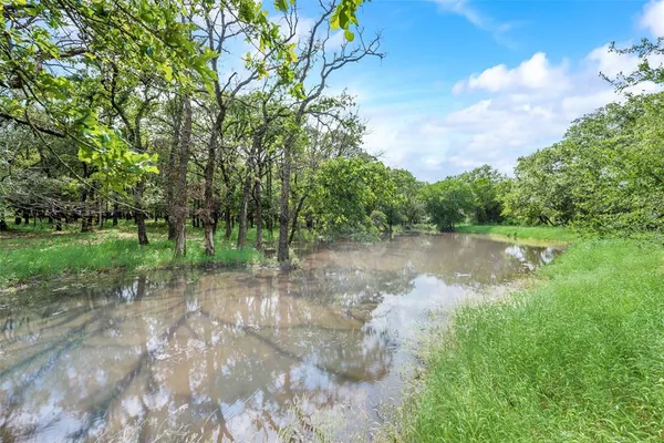 a view of a lake with a yard