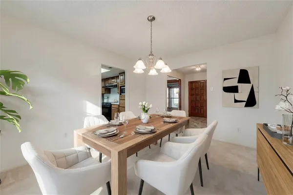 a view of a dining room with furniture and chandelier