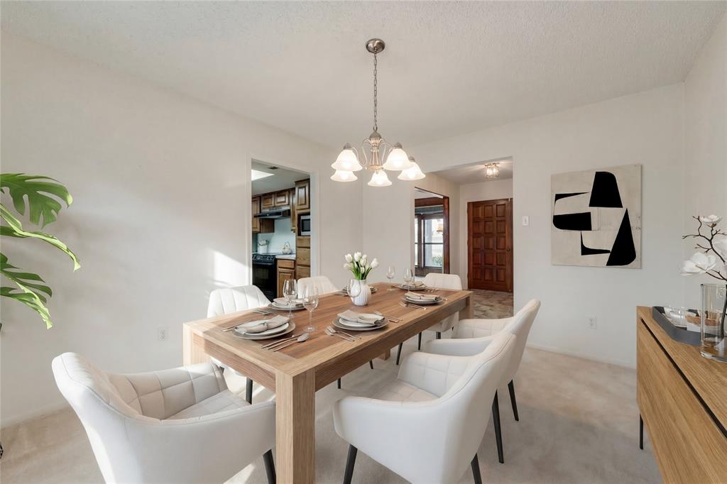 460 West J E Woody Road Springtown, TX 76082 - Photo 7 of 22 a view of a dining room with furniture and chandelier