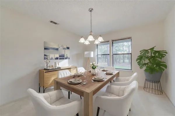 a view of a dining room with furniture window and outside view
