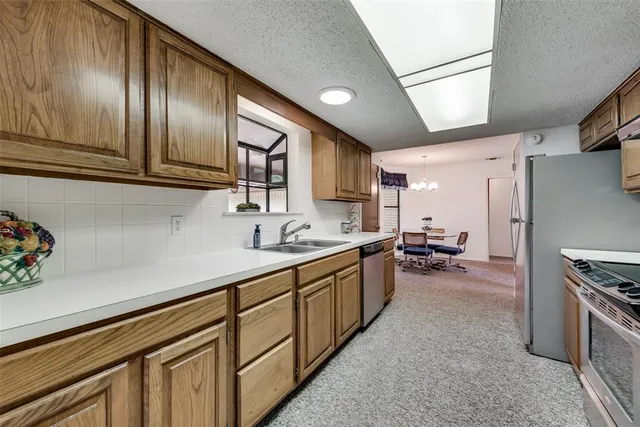 a kitchen with sink cabinets and stainless steel appliances
