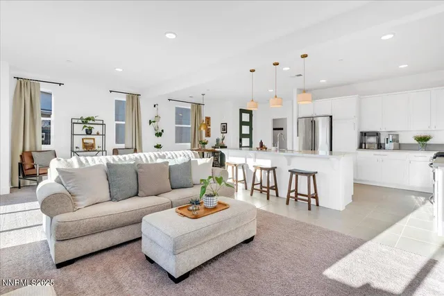 a living room with lots of furniture and kitchen view
