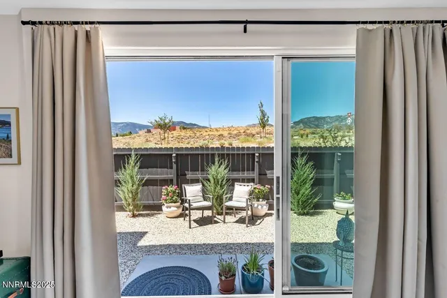 a view of living room with furniture and floor to ceiling window