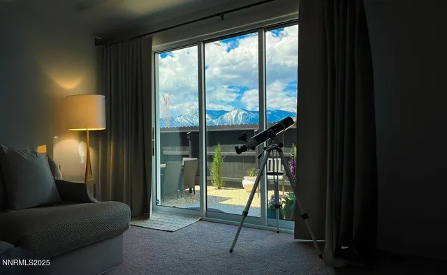a living room filled with furniture and a floor to ceiling window