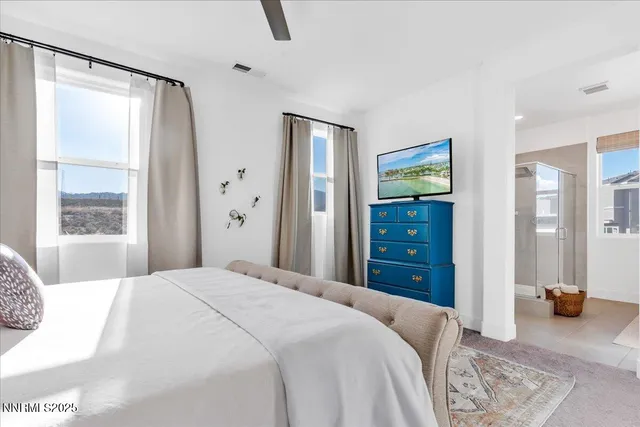 a bedroom with a bed and a mirror