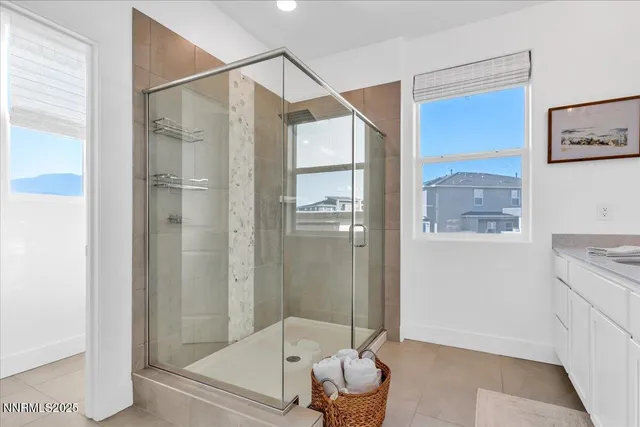 a bathroom that has a glass shower door