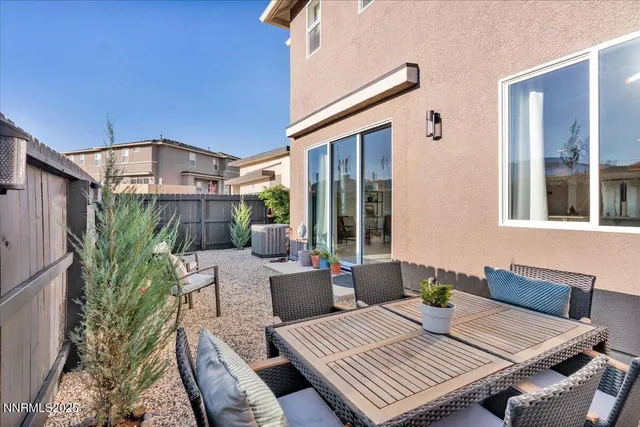 a view of a patio with table and chairs and potted plants