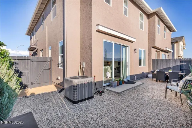 a backyard of a house with barbeque oven table and chairs