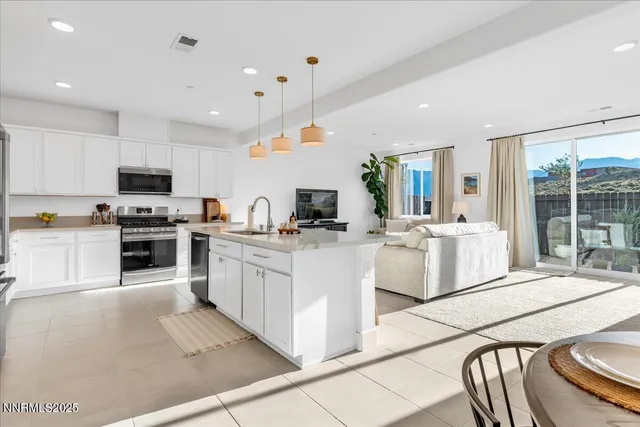 a kitchen with white cabinets and sink
