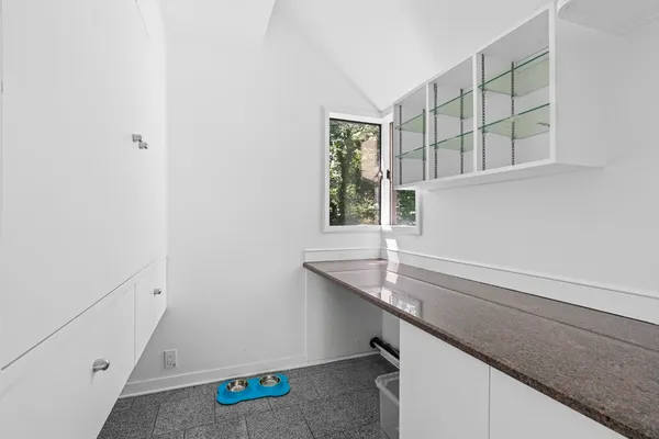 a view of a chairs and table in the roof deck