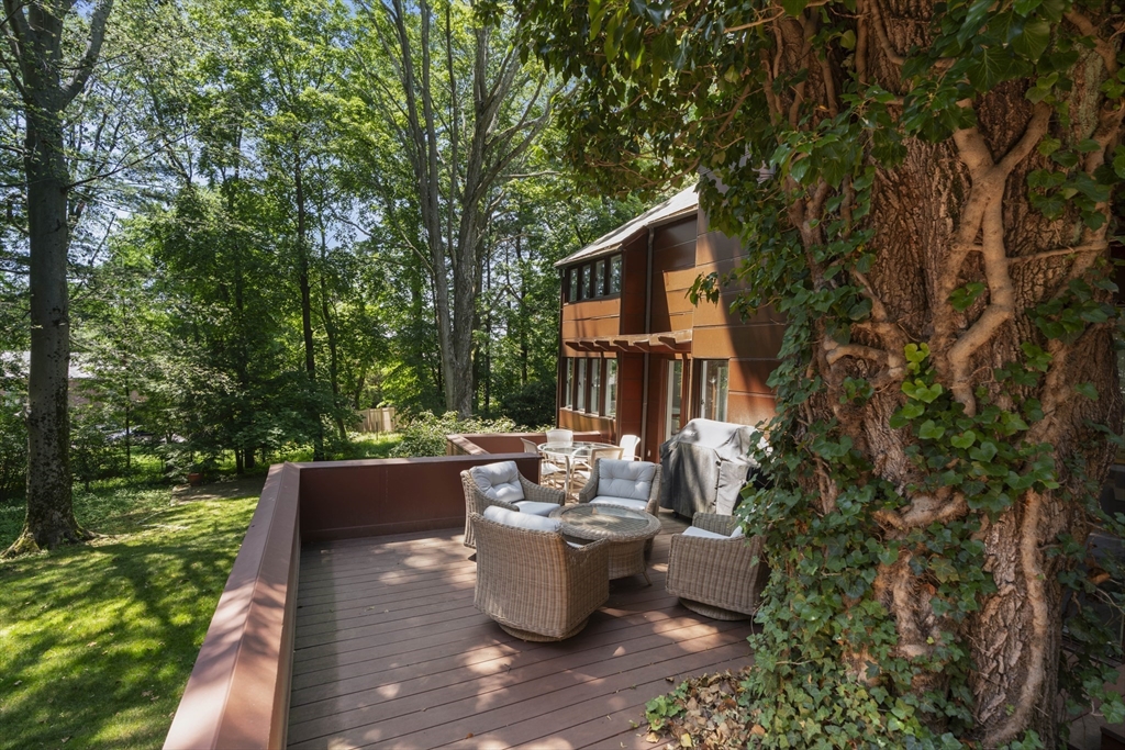 331 Heath Street Brookline, MA 02467 - Photo 14 of 31 a view of a patio with table and chairs potted plants with large tree