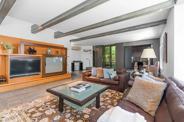 a living room with furniture and large windows