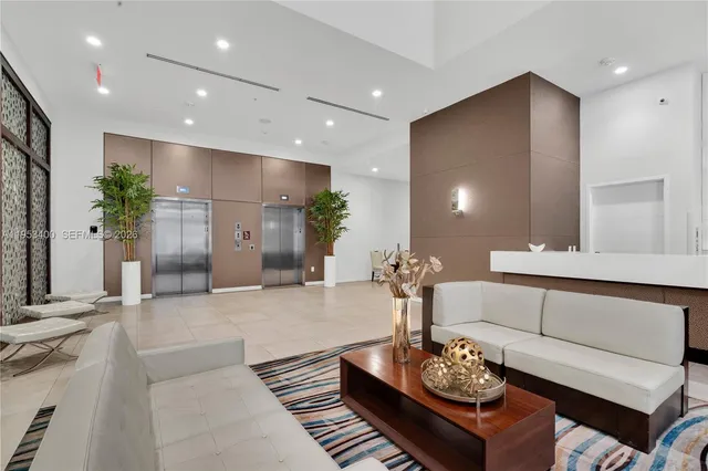 a living room with furniture and flowers