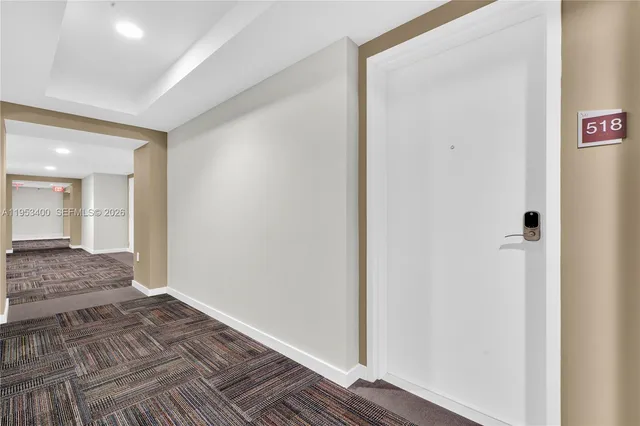 a view of kitchen with refrigerator and window