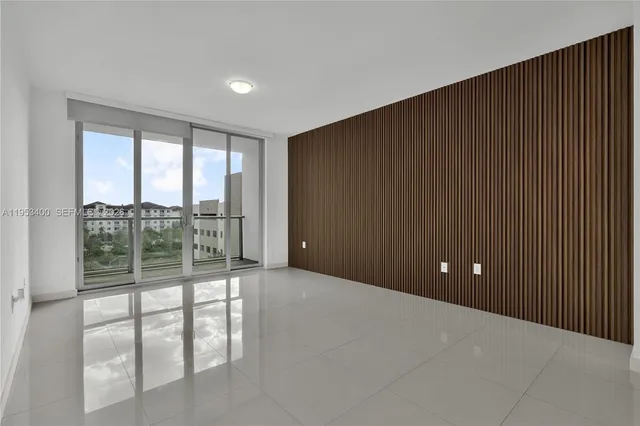 a view of kitchen with refrigerator and window