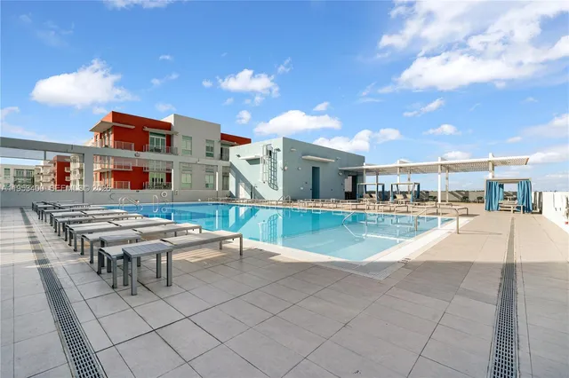 a view of a backyard with plants and palm trees