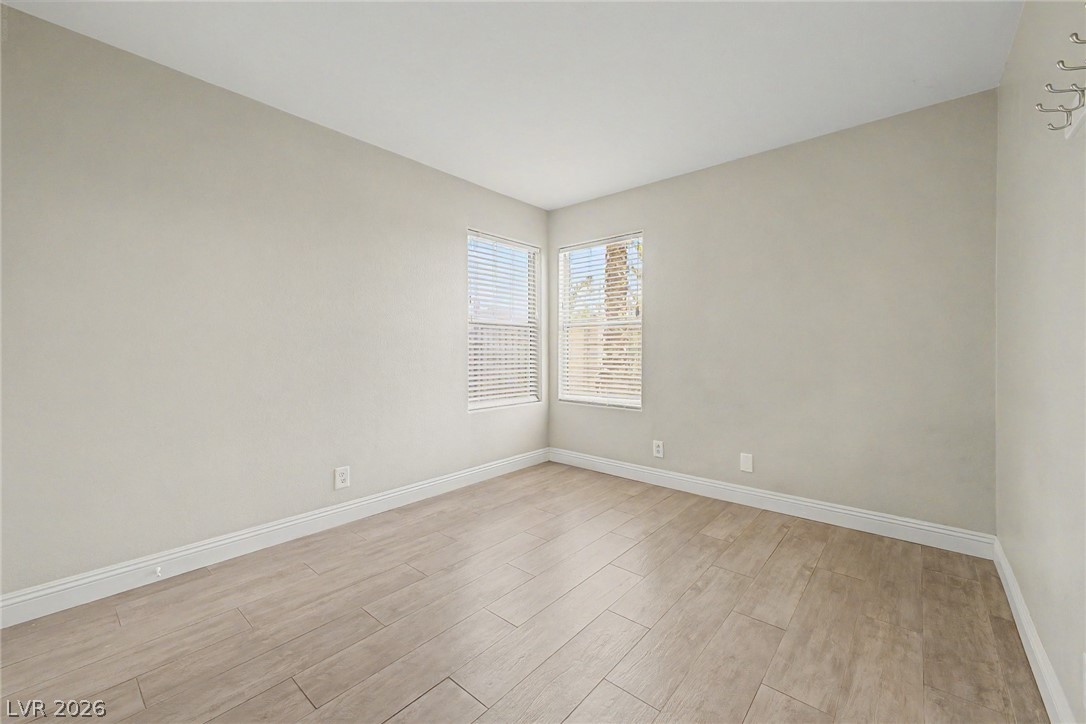 2316 Ramsgate Drive Henderson, NV 89074 - Photo 12 of 28 Two windows with blinds illuminate the pale walls and light-toned tile flooring in this inviting room.