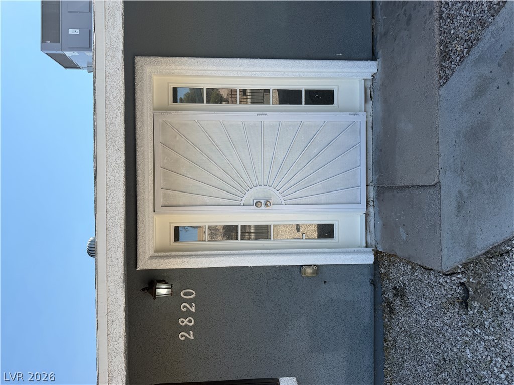 2820 South Sandhill Road, Unit A Las Vegas, NV 89121 - Photo 4 of 26 A welcoming front entrance featuring a sunburst security screen door.