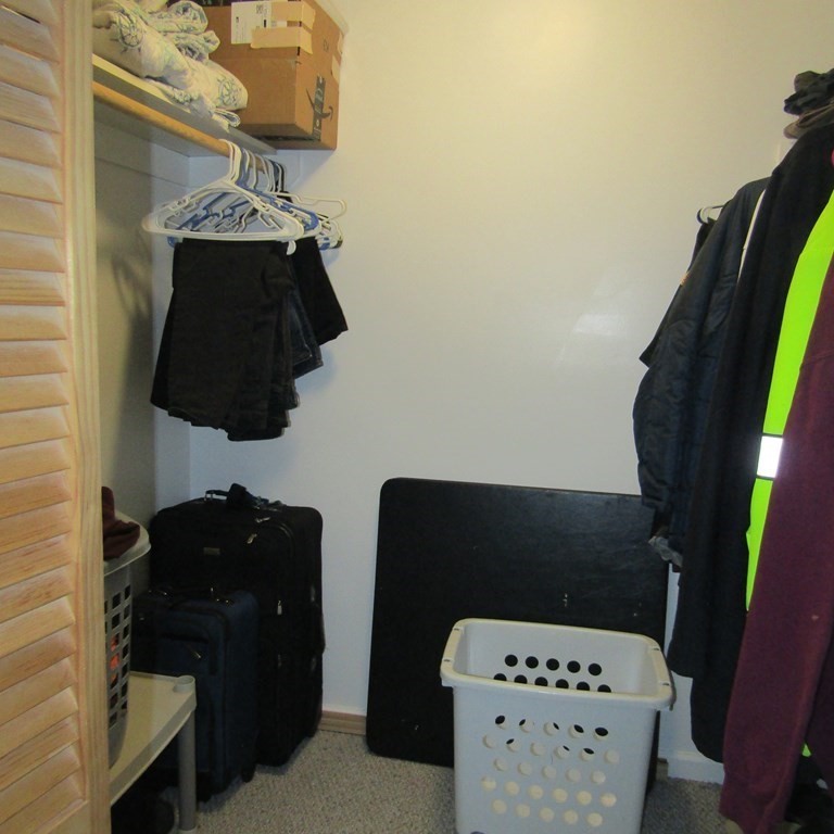 16 Chesterfield Road Northampton, MA 01053 - Photo 32 of 42 a black leather chair sitting in a kitchen next to a cabinet