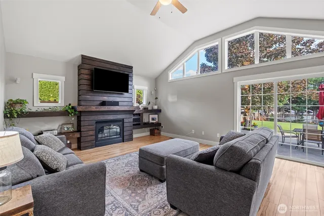 a living room with furniture a flat screen tv and a fireplace